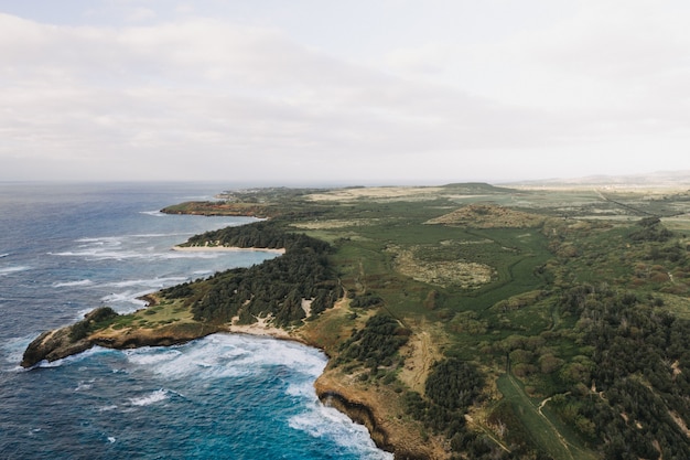 High angle shot of a beautiful seashore with a white cloudy sky