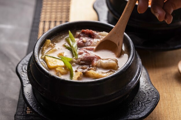 High angle shot of a bowl of delicious vegetable soup on a wooden table