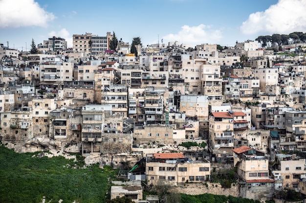 High angle shot of a cityscape with a lot of concrete buildings under the beautiful cloudy sky