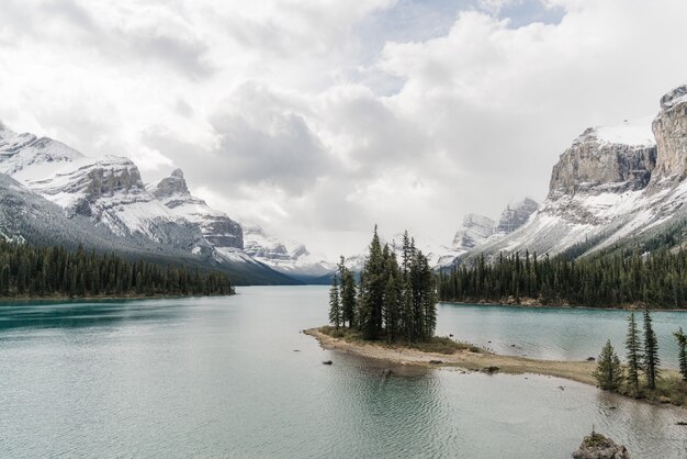 High angle shot of a clear frozen lake surrounded by a mountainous scenery