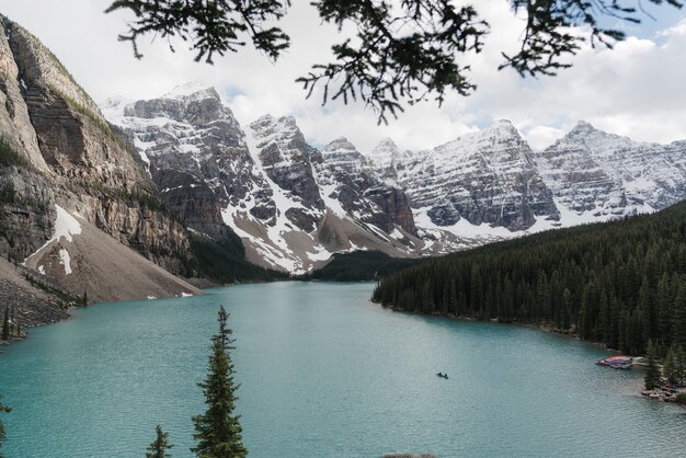 High angle shot of a clear frozen lake surrounded by a mountainous scenery