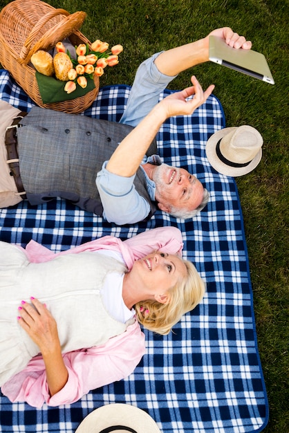 High angle shot couple looking at a tablet