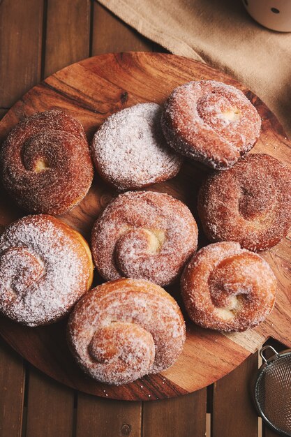 A high angle shot of delicious snake doughnuts coated with powdered sugar