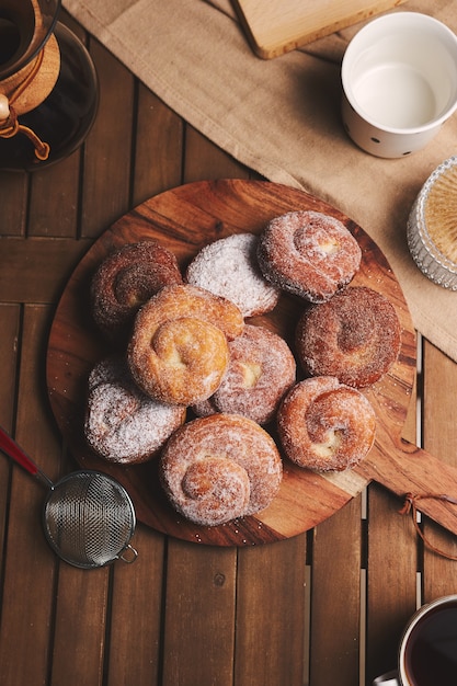 High angle shot of delicious snake doughnuts coated with powdered sugar