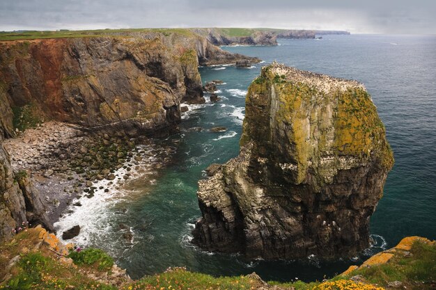 High angle shot of an elegug stacks. rock formation in Pembrokeshire, South Wales, UK