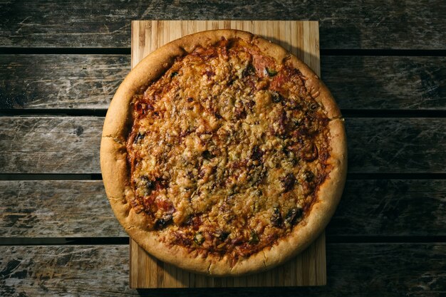 High angle shot of a freshly baked pizza on a wooden surface