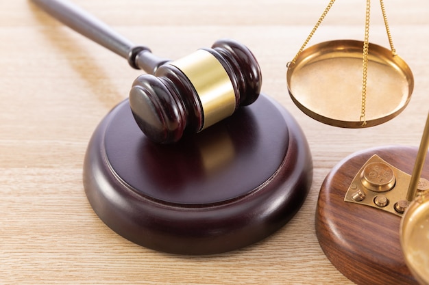 High angle shot of a gavel and a scale on a wooden surface