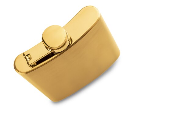 High angle shot of a golden liquor flask on a white surface