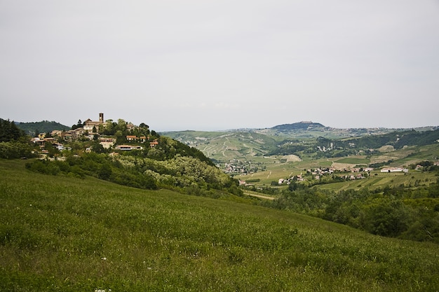 High angle shot of a green landscape with a village with a lot of buildings