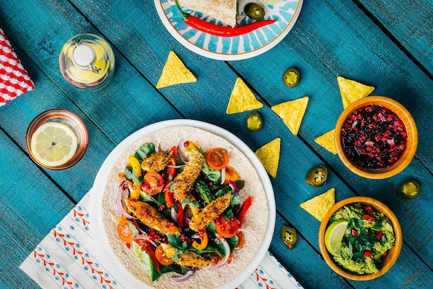 Free photo high angle shot of lunch with nuggets and vegetables on wooden surface