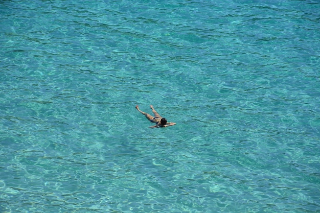 High angle shot of a male sunbathing in the water