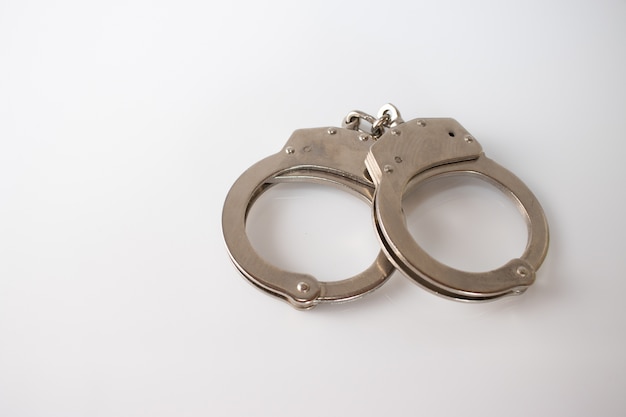 High angle shot of metal handcuffs isolated