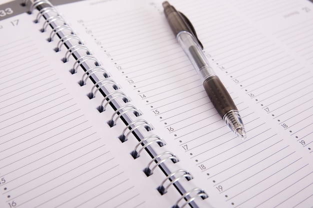 High angle shot of a pen on an open notebook