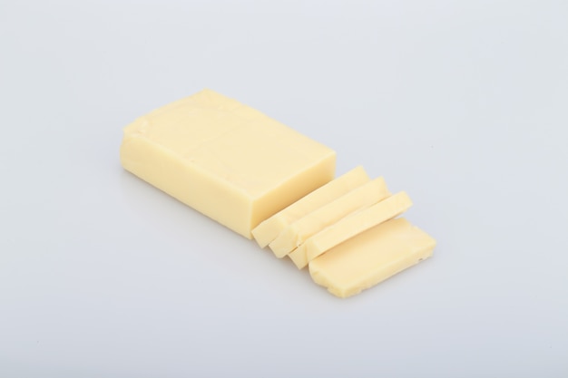 High angle shot of a piece of butter isolated on a white background