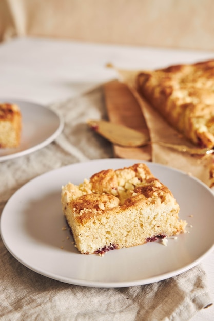 High angle shot of a piece of delicious Jerry Crumble Sheet cake on a white wood table