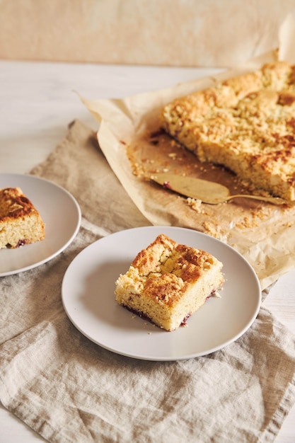 High angle shot of a piece of delicious Jerry Crumble Sheet cake on a white wood table