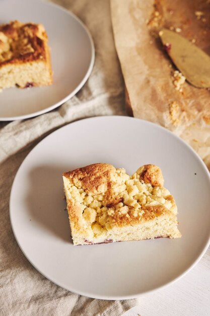 High angle shot of a piece of delicious Jerry Crumble Sheet cake on a white wood table