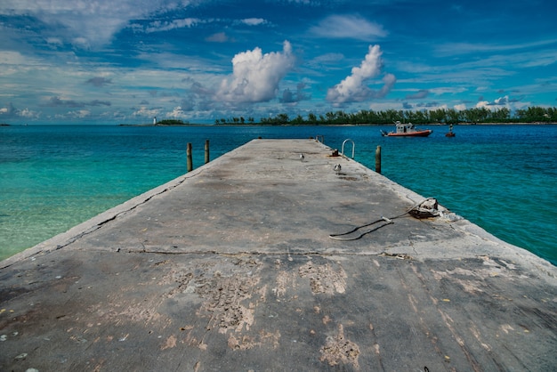 Free photo high angle shot of a pier with a cloudy blue sky in the background