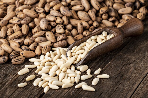 High angle shot of a pile of Navy Beans and some other kind of bean on a wooden surface