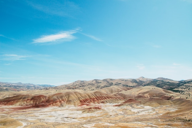 High angle shot of the sandy hills in a deserted area under the bright sky