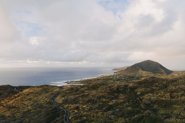 High angle shot of a seashore with a cloudy blue sky in the background