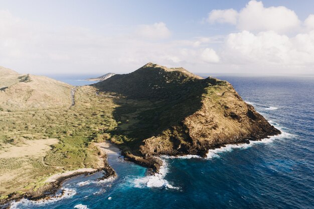 High angle shot of a seashore with a cloudy blue sky