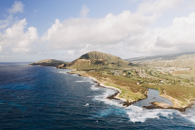 High angle shot of a seashore with a cloudy blue sky