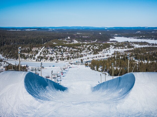 High angle shot of the snowboarding downhill in the mountains