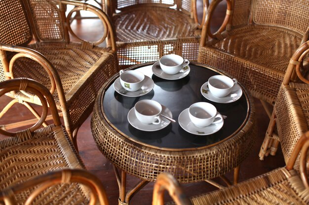 High angle shot of a tea set on a table with chairs