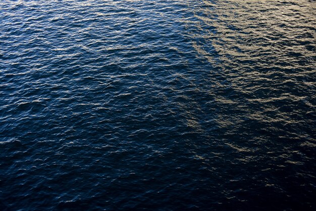 High angle shot of a tranquil ocean with soft sunlight