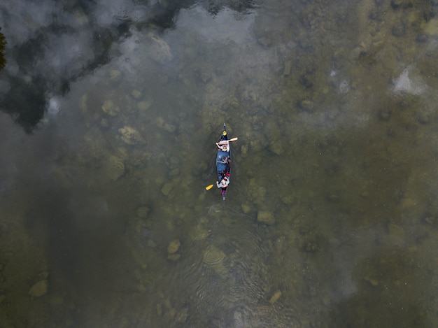 High angle shot of two people on a row boat on a lake