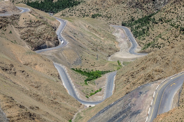 High angle shot of winding highways in an area with empty hills
