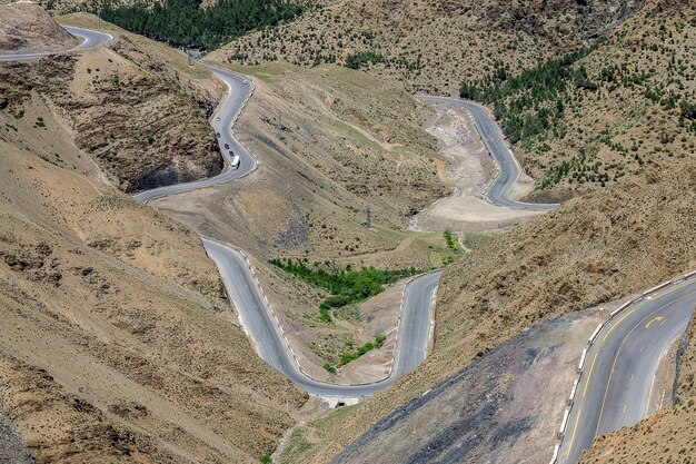 High angle shot of winding highways in an area with empty hills