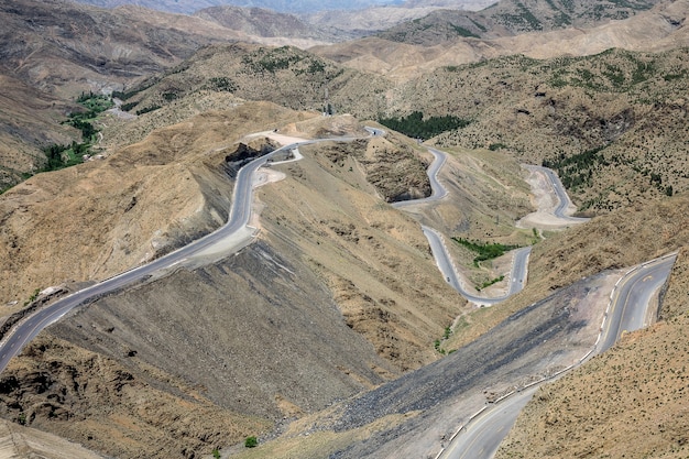 High angle shot of winding highways in an area with empty hills