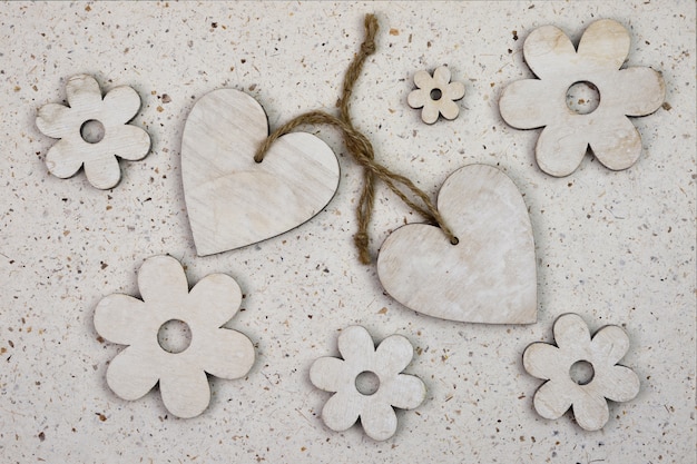 High angle shot of wooden heart-shaped ornaments with flowers