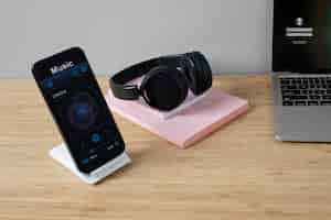 Free photo high angle of smartphone on desk with headphones