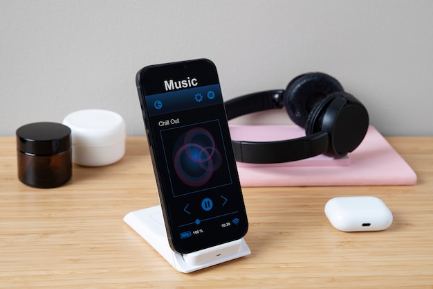 High angle of smartphone on desk with headphones