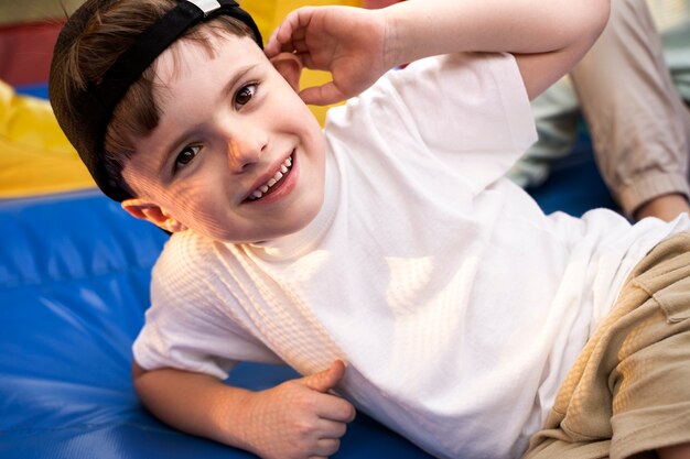 High angle smiley boy laying in bounce house