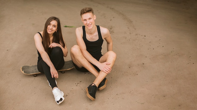 High angle smiley couple looking at camera