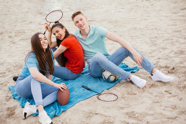 High angle smiley friends sitting on blanket