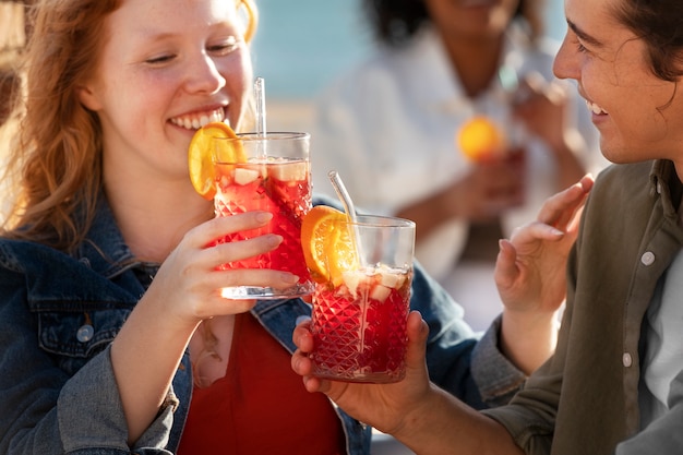 Free photo high angle smiley friends with sangria