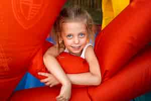 Free photo high angle smiley girl in bounce house