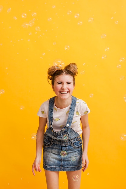 Free photo high angle smiley girl with bubbles