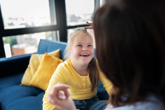 High angle smiley girl with down syndrome