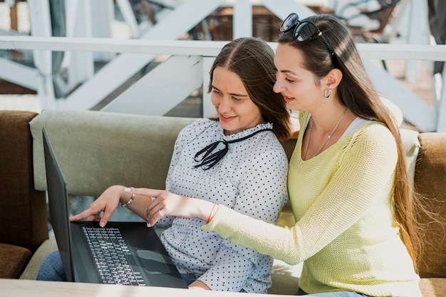 High angle smiley girls with laptop