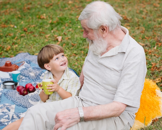 High angle smiley grandson looking at grandpa