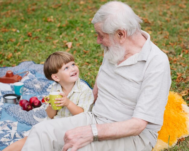 High angle smiley grandson looking at grandpa