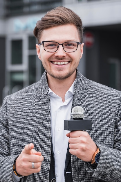 Free photo high angle smiley male journalist