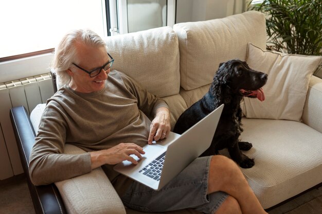 High angle smiley man holding laptop