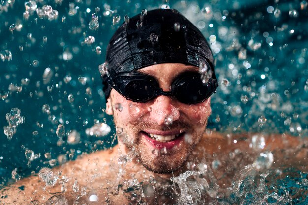 High angle smiley man swimming